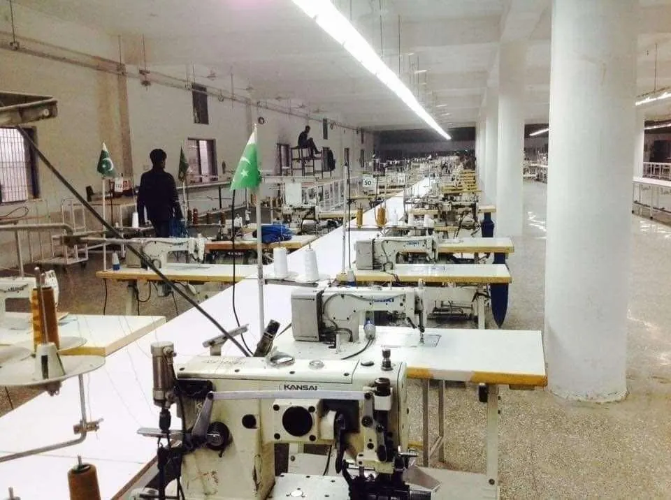 Garment production floor with sewing machines in a completed factory hall