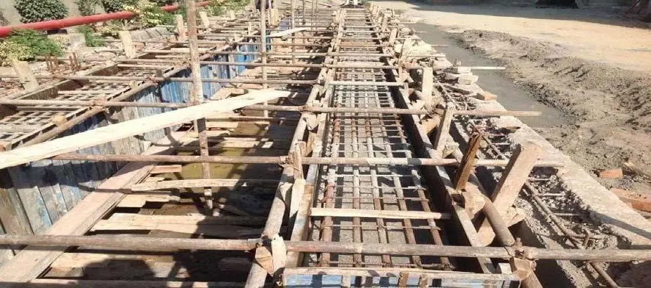 Excavated foundation trenches with reinforcement and formwork