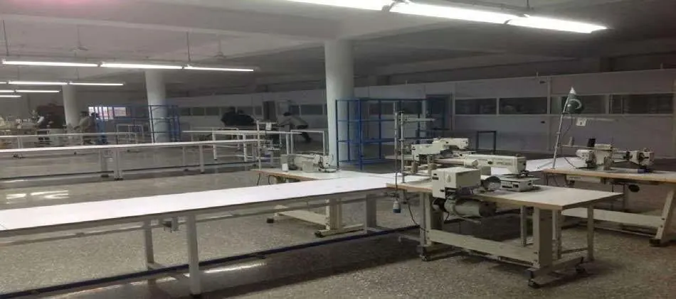 Wide production hall with work stations, columns and ceiling lights