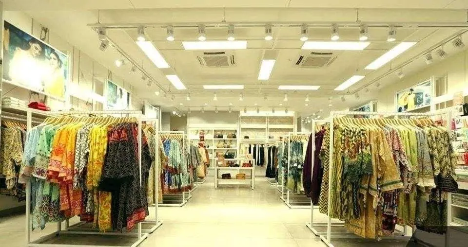 Completed retail interior with clothing displays and ceiling lighting