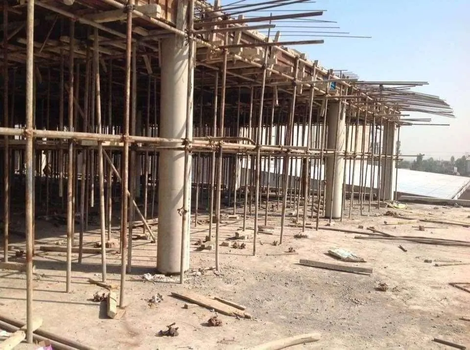 Shuttering and timber props supporting a concrete roof slab during construction